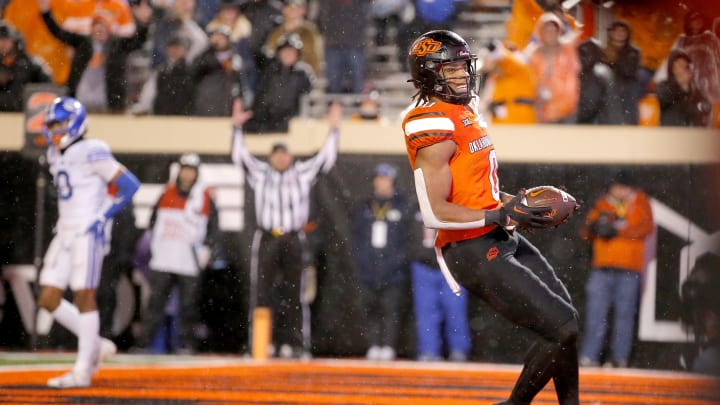 Nov 25, 2023; Stillwater, Oklahoma, USA;  Oklahoma State's Ollie Gordon II (0) scores a touchdown against BYU in the first overtime at Boone Pickens Stadium. Mandatory Credit: Sarah Phipps-USA TODAY Sports