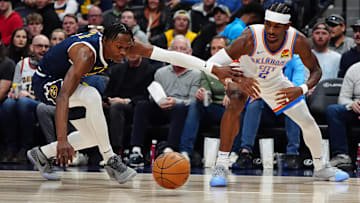 Nov 6, 2024; Denver, Colorado, USA; Denver Nuggets forward Peyton Watson (8) and Oklahoma City Thunder guard Shai Gilgeous-Alexander (2) reach for a loose ball in the first quarter at Ball Arena. Mandatory Credit: Ron Chenoy-Imagn Images
