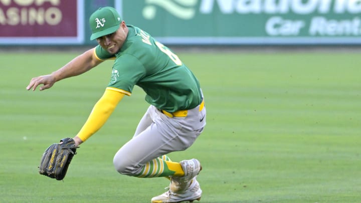 Jun 24, 2024; Anaheim, California, USA;  A single by Los Angeles Angels shortstop Zach Neto (9) gets past Oakland Athletics first baseman Aledmys Diaz (6) in the second inning at Angel Stadium