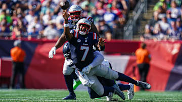 Sep 15, 2024; Foxborough, Massachusetts, USA; New England Patriots quarterback Jacoby Brissett (7) tries to pass the ball under pressure from the Seattle Seahawks in the second half at Gillette Stadium. Mandatory Credit: David Butler II-Imagn Images