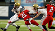 Dec 1, 2023; Canton, Ohio, USA;
Bishop Watterson's Ben Uhlenhake (42) attempts to make it past Toledo Central Catholic's Victor Singleton Jr. (21) as Christopher Bair (5) attempts to hold him back during their game on Friday, Dec. 1, 2023 at Tom Benson Hall of Fame Stadium for the Division III state finals.