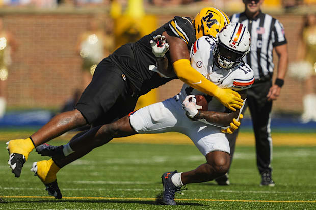 Auburn Tigers tight end Rivaldo Fairweather (13) is tackled by Missouri Tigers defensive tackle Chris McClellan (7).