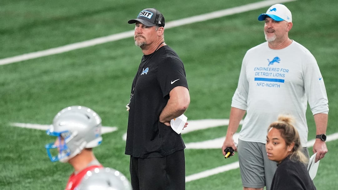 Detroit Lions head coach Dan Campbell, center, and offensive coordinator John Morton watch practice during OTAs at Meijer Performance Center in Allen Park on Thursday, June 5, 2025.