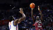Nov 22, 2024; Gainesville, Florida, USA; Southern Illinois Salukis guard Ali Dibba (6) shoots over Florida Gators center Rueben Chinyelu (9) during the first half at Exactech Arena at the Stephen C. O'Connell Center. Mandatory Credit: Matt Pendleton-Imagn Images