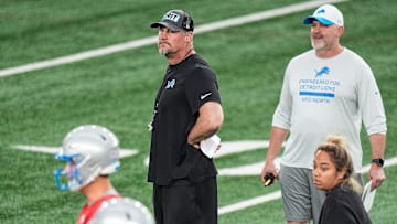 Detroit Lions head coach Dan Campbell, center, and offensive coordinator John Morton watch practice during OTAs at Meijer Performance Center in Allen Park on Thursday, June 5, 2025.