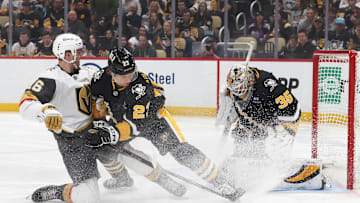 Mar 11, 2025; Pittsburgh, Pennsylvania, USA;  Pittsburgh Penguins goaltender Tristan Jarry (35) makes a save against the Vegas Golden Knights left wing Pavel Dorofeyev (16) as Penguins defenseman Vladislav Kolyachonok (23) defends during the second period at PPG Paints Arena. Mandatory Credit: Charles LeClaire-Imagn Images
