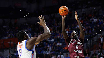 Nov 22, 2024; Gainesville, Florida, USA; Southern Illinois Salukis guard Ali Dibba (6) shoots over Florida Gators center Rueben Chinyelu (9) during the first half at Exactech Arena at the Stephen C. O'Connell Center. Mandatory Credit: Matt Pendleton-Imagn Images