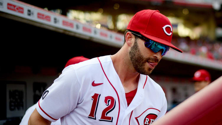 Reds outfielder Tyler Naquin emerges from the dugout.