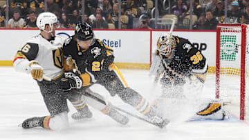 Mar 11, 2025; Pittsburgh, Pennsylvania, USA;  Pittsburgh Penguins goaltender Tristan Jarry (35) makes a save against the Vegas Golden Knights left wing Pavel Dorofeyev (16) as Penguins defenseman Vladislav Kolyachonok (23) defends during the second period at PPG Paints Arena. Mandatory Credit: Charles LeClaire-Imagn Images