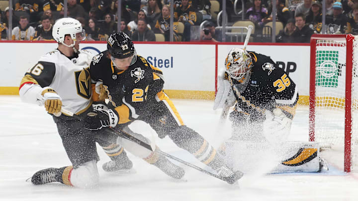 Mar 11, 2025; Pittsburgh, Pennsylvania, USA;  Pittsburgh Penguins goaltender Tristan Jarry (35) makes a save against the Vegas Golden Knights left wing Pavel Dorofeyev (16) as Penguins defenseman Vladislav Kolyachonok (23) defends during the second period at PPG Paints Arena. Mandatory Credit: Charles LeClaire-Imagn Images
