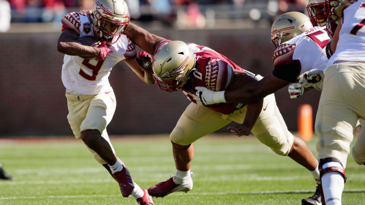Florida State Seminoles running back Lawrance Toafili (9) fights off a tackle from Florida State