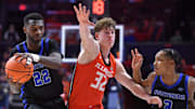 Nov 4, 2024; Champaign, Illinois, USA;  Illinois Fighting Illini guard Kasparas Jakucionis (32) gets between Eastern Illinois Panthers forward Sekou Kalle (22) and guard Nakyel Shelton (3) during the second half at State Farm Center. Mandatory Credit: Ron Johnson-Imagn Images