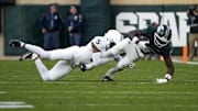 Nov 15, 2025; East Lansing, Michigan, USA; Penn State Nittany Lions cornerback Daryus Dixson (5) tackles Michigan State Spartans wide receiver Nick Marsh (6) after a catch in the second quarter at Spartan Stadium. Mandatory Credit: Brendan Mullin-Imagn Images