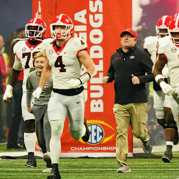 Dec 2, 2023; Atlanta, GA, USA;  Georgia Bulldogs head coach Kirby Smart runs out of the tunnel with his team before the SEC Championship game against the Alabama Crimson Tide at Mercedes-Benz Stadium. Mandatory Credit: John David Mercer-Imagn Images