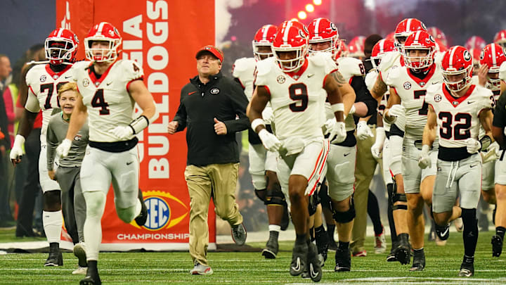 Dec 2, 2023; Atlanta, GA, USA;  Georgia Bulldogs head coach Kirby Smart runs out of the tunnel with his team before the SEC Championship game against the Alabama Crimson Tide at Mercedes-Benz Stadium. Mandatory Credit: John David Mercer-Imagn Images