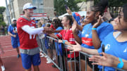 Bills quarterbacks Josh Allen runs around the entire practice field high-fiving and fist-bumping fans at the end of the opening day of Buffalo Bills training camp.