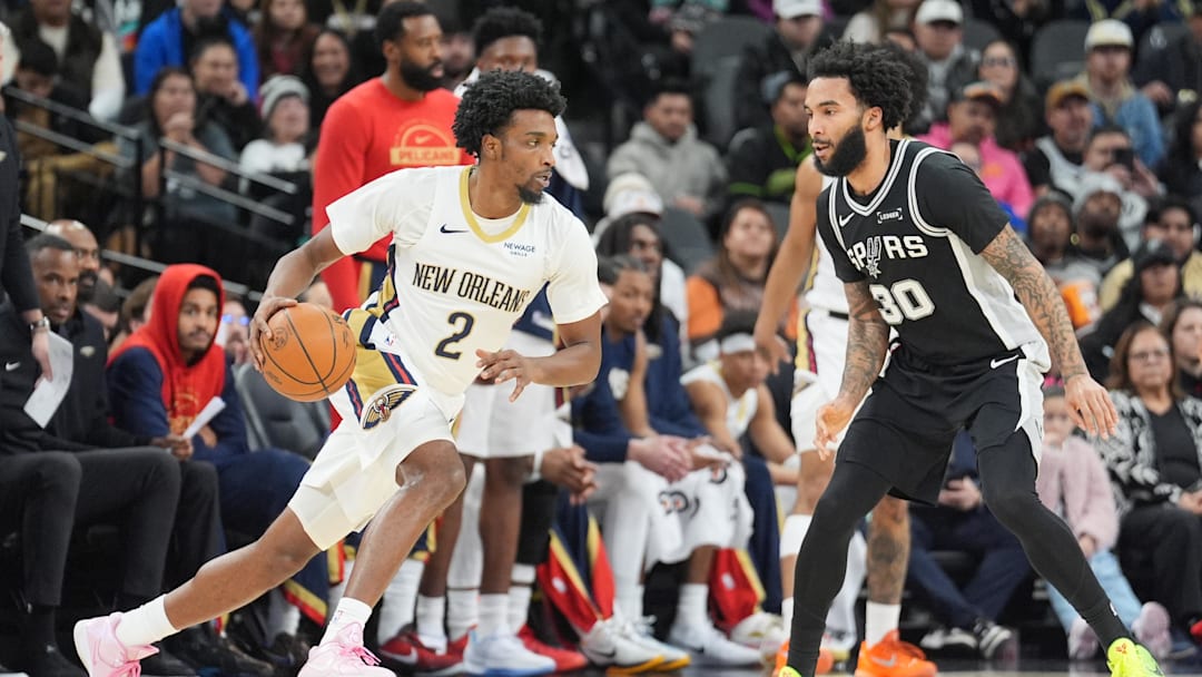 Jan 25, 2026; San Antonio, Texas, USA;  New Orleans Pelicans forward Herbert Jones (2) dribbles in front of San Antonio Spurs forward Julian Champagnie (30) in the first half at Frost Bank Center. Mandatory Credit: Daniel Dunn-Imagn Images