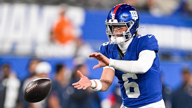 Jaxson Dart takes a snap in a preseason game.