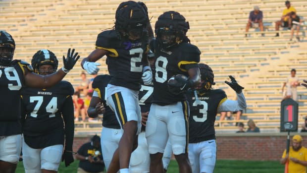 Missouri Tigers wide receiver Marquis Johnson (2) and running back Nate Noel (8) celebrate at the team's annual fan night.