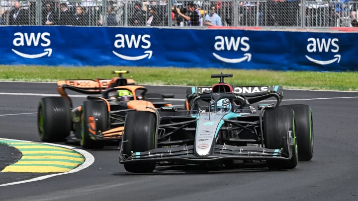 Jun 9, 2024; Montreal, Quebec, CAN; Mercedes driver George Russell (GBR) races ahead of McLaren driver Lando Norris (GBR) during the Canadian Grand Prix at Circuit Gilles Villeneuve. Mandatory Credit: David Kirouac-USA TODAY Sports