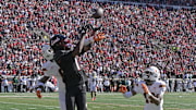 Oct 19, 2024; Louisville, Kentucky, USA;  Louisville Cardinals wide receiver Ja'Corey Brooks (1) attempts to catch a pass under the pressure of Miami Hurricanes defensive back Mishael Powell (0) and defensive back D'Yoni Hill (19) during the second half at L&N Federal Credit Union Stadium. Miami defeated Louisville 52-45. Mandatory Credit: Jamie Rhodes-Imagn Images