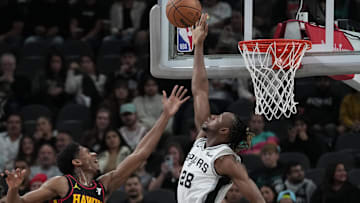 Nov 30, 2023; San Antonio, Texas, USA;  San Antonio Spurs center Charles Bassey (28) blocks a shot by Atlanta Hawks forward De'Andre Hunter (12) in the first half at the Frost Bank Center. Mandatory Credit: Daniel Dunn-Imagn Images