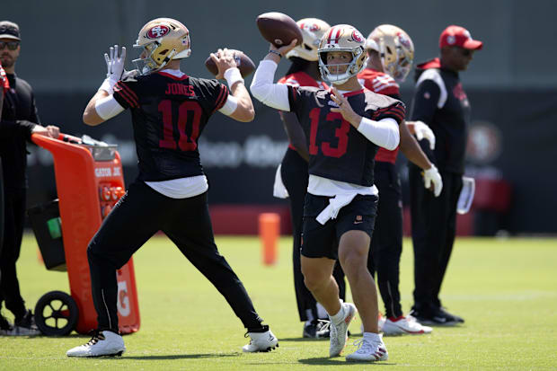 Jun 11, 2025; Santa Clara, CA, USA; San Francisco 49ers quarterbacks Mac Jones (10) and Brock Purdy (13) work on passing dril