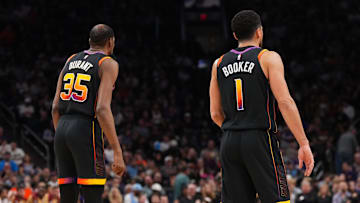 Mar 21, 2025; Phoenix, Arizona, USA; Phoenix Suns forward Kevin Durant (35) and Phoenix Suns guard Devin Booker (1) look on against the Cleveland Cavaliers during the first half at Footprint Center. Mandatory Credit: Joe Camporeale-Imagn Images