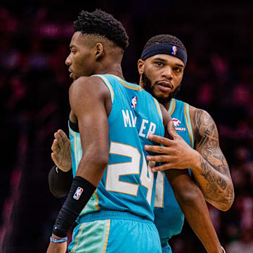 Apr 7, 2024; Charlotte, North Carolina, USA; Charlotte Hornets forward Miles Bridges (0) congratulates forward Brandon Miller (24) during a game against the Oklahoma City Thunder at Spectrum Center. Mandatory Credit: Scott Kinser-Imagn Images