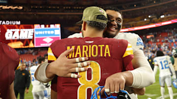 Nov 9, 2025; Landover, Maryland, USA; Washington Commanders quarterback Marcus Mariota (8) hugs Detroit Lions offensive tackle Penei Sewell (58) after their game at Northwest Stadium. Mandatory Credit: Geoff Burke-Imagn Images