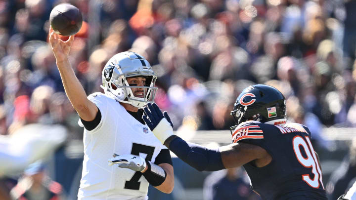 Oct 22, 2023; Chicago, Illinois, USA;  Las Vegas Raiders quarterback Brian Hoyer (7) gets off a pass while being pressured by Chicago Bears defensive lineman Yannick Ngakoue (91) in the second quarter at Soldier Field. Mandatory Credit: Jamie Sabau-USA TODAY Sports