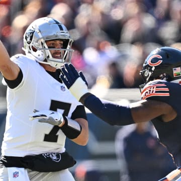 Oct 22, 2023; Chicago, Illinois, USA;  Las Vegas Raiders quarterback Brian Hoyer (7) gets off a pass while being pressured by Chicago Bears defensive lineman Yannick Ngakoue (91) in the second quarter at Soldier Field.