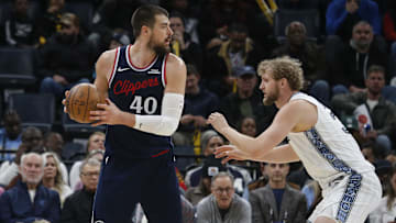 Dec 5, 2025; Memphis, Tennessee, USA; Los Angeles Clippers center Ivica Zubac (40) handles the ball as Memphis Grizzlies center Jock Landale (31) defends during the second quarter at FedExForum. Mandatory Credit: Petre Thomas-Imagn Images