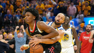 Golden State Warriors guard Stephen Curry knocks the ball away from Houston Rockets forward Amen Thompson.