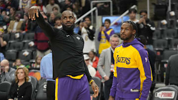 Nov 1, 2024; Toronto, Ontario, CAN; Los Angeles Lakers forward LeBron James (left) and guard Bronny James (right) during warm up before a game agaonst the Toronto Raptors at Scotiabank Arena. Mandatory Credit: John E. Sokolowski-Imagn Images