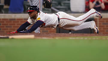 Ozzie Albies slides in to score