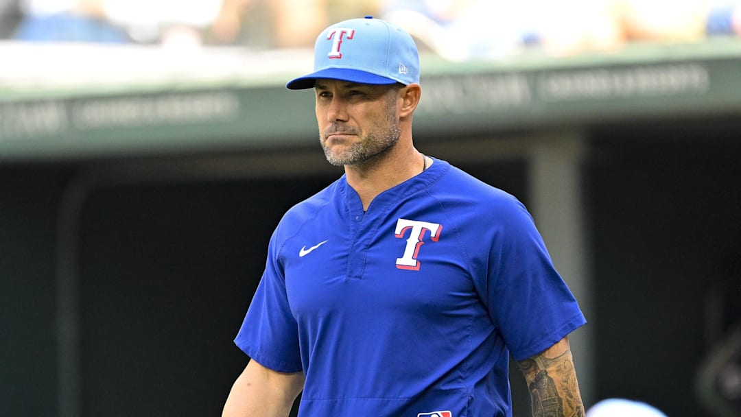 Texas Rangers manager Skip Schumaker (55) walks to the mound. 