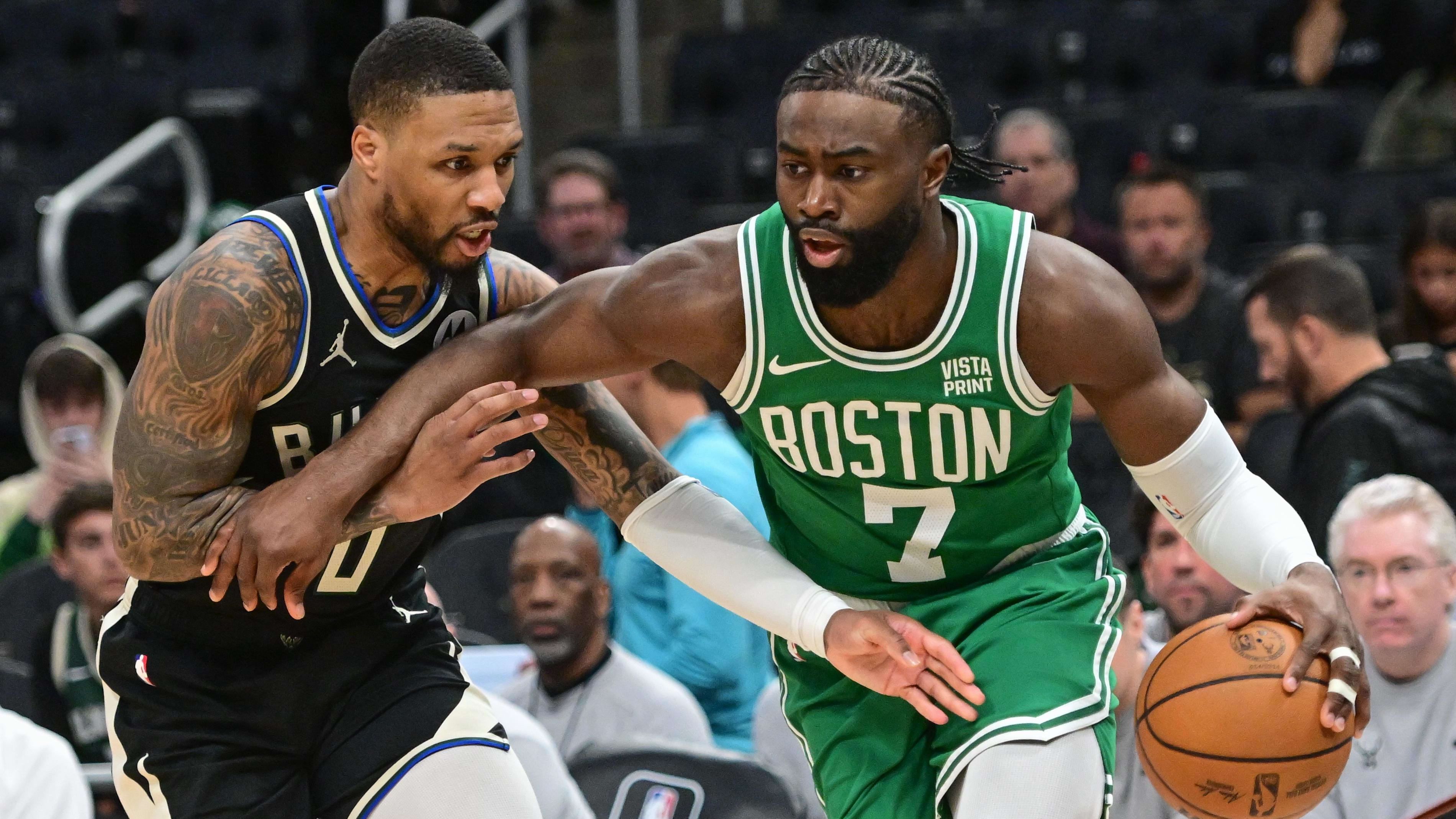 Jaylen Brown drives past Damian Lillard.