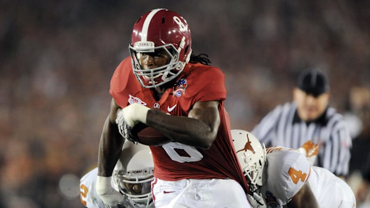 Jan 7, 2010; Pasadena, CA, USA; Alabama Crimson Tide wide receiver Julio Jones (8) runs past Texas Longhorns cornerback Aaron Williams (4) during the first quarter of the 2010 BCS national championship game at the Rose Bowl.  Mandatory Credit: Kirby Lee-Imagn Images