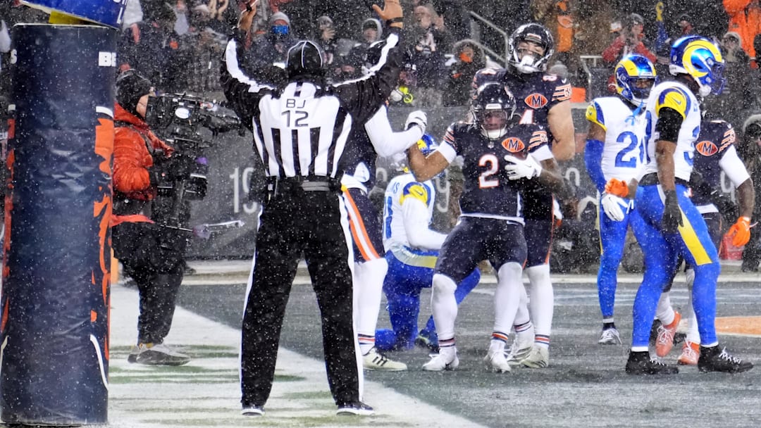 DJ Moore celebrates with teammates in the end zone after catching a touchdown pass against the Los Angeles Rams in the divisional playoffs.