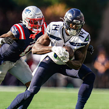 Sep 15, 2024; Foxborough, Massachusetts, USA; Seattle Seahawks wide receiver DK Metcalf (14) runs the ball against New England Patriots cornerback Christian Gonzalez (0) in the second half at Gillette Stadium. Mandatory Credit: David Butler II-Imagn Images