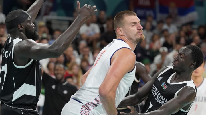 Aug 3, 2024; Villeneuve-d'Ascq, France; South Sudan point guard Marial Shayok (11) and shooting guard Bul Kuol (7) fight with Serbia power forward Nikola Jokic (15) for the ball in the third quarter during the Paris 2024 Olympic Summer Games at Stade Pierre-Mauroy. Mandatory Credit: John David Mercer-USA TODAY Sports