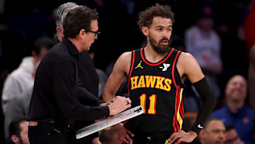 Atlanta Hawks head coach Quin Snyder talks with Trae Young during a game against the New York Knicks.