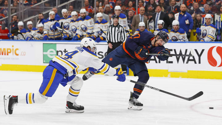 Mar 21, 2024; Edmonton, Alberta, CAN; Edmonton Oilers forward Warren Foegele (37) gets a shot away in front of Buffalo Sabres defensemen Bowen Byron (4) during the first period at Rogers Place. Mandatory Credit: Perry Nelson-USA TODAY Sports