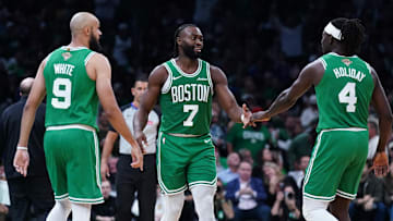 Oct 22, 2024; Boston, Massachusetts, USA; Boston Celtics guard Jaylen Brown (7), guard Jrue Holiday (4) and guard Derrick White (9) react after a play against the New York Knicks in the second half at TD Garden. Mandatory Credit: David Butler II-Imagn Images