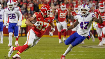 Dec 10, 2023; Kansas City, Missouri, USA; Kansas City Chiefs tight end Travis Kelce (87) runs the ball as Buffalo Bills cornerback Christian Benford (47) defends on a play that was called back due to a penalty during the second half at GEHA Field at Arrowhead Stadium. Mandatory Credit: Denny Medley-Imagn Images
