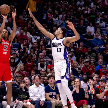 Apr 19, 2024; New Orleans, Louisiana, USA;  New Orleans Pelicans guard Trey Murphy III (25) shoots a three point basket against Sacramento Kings forward Keegan Murray (13) in the first half during a play-in game of the 2024 NBA playoffs at Smoothie King Center.