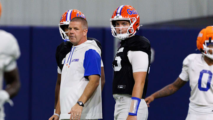 Florida Gators head coach Billy Napier looks on with Florida Gators quarterback Harrison Bailey (15) during fall football practice at Sanders Indoor Practice Fields at the University of Florida in Gainesville, FL on Thursday, August 7, 2025. [Matt Pendleton/Gainesville Sun]