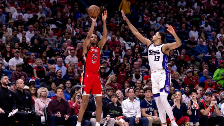 Apr 19, 2024; New Orleans, Louisiana, USA;  New Orleans Pelicans guard Trey Murphy III (25) shoots a three point basket against Sacramento Kings forward Keegan Murray (13) in the first half during a play-in game of the 2024 NBA playoffs at Smoothie King Center.