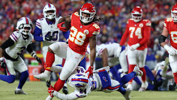 Jan 26, 2025; Kansas City, MO, USA; Kansas City Chiefs running back Kareem Hunt (29) breaks a tackle against Buffalo Bills safety Cole Bishop (24) during the first quarter in the AFC Championship game at GEHA Field at Arrowhead Stadium. Mandatory Credit: Mark J. Rebilas-Imagn Images